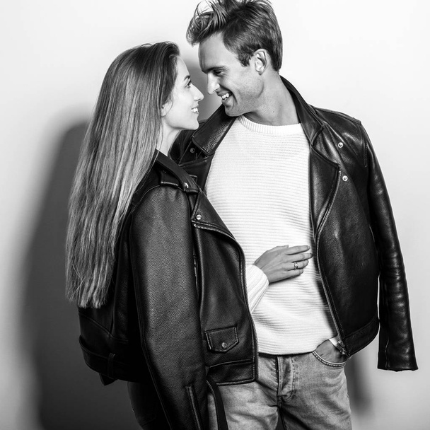 Young beautiful couple in black leather jackets. Black-white portrait. - Photo, Image