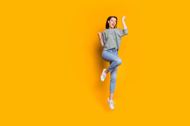 Full length body size photo of cheerful overjoyed lady having evidently just been promoted at work while isolated with yellow vivid background - Фото, зображення