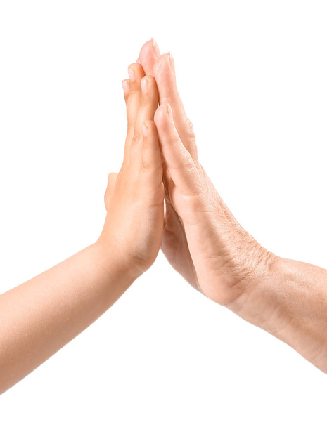 Hands of little girl and her grandmother on white background - Photo, image