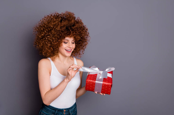 Close up photo of pretty lady big giftbox hands ecstatic open curious what inside wear white tank-top isolated grey background - Fotó, kép