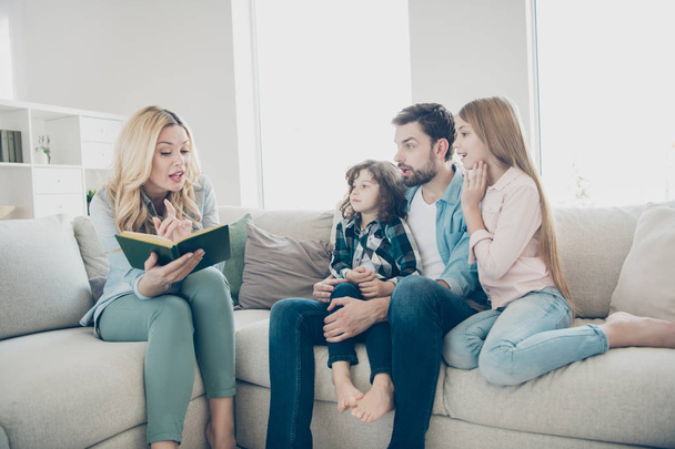 Young big family two children comfortable sitting sofa listening mommy reading exciting fairy tale - Foto, Imagem
