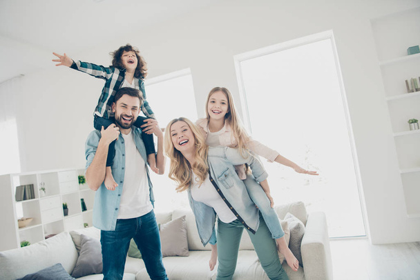 Photo of big family four members having best free time hands like wings airplane flight indoors apartments - Valokuva, kuva
