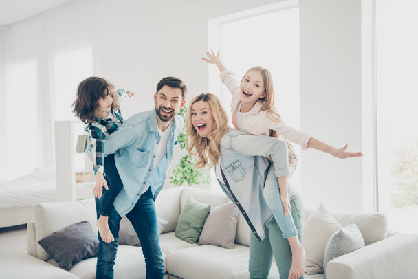 Profile photo of four family members having best free time pretend flight airplane indoors apartments - Foto, Bild