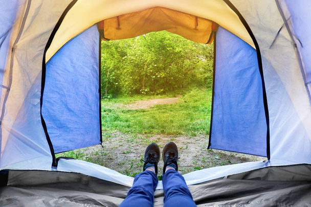 Woman lying in camping tent - 写真・画像