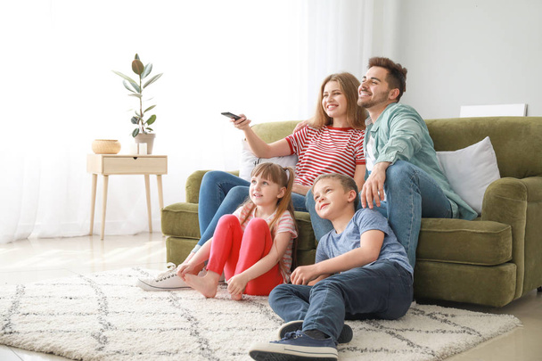 Happy family watching TV at home - Фото, зображення