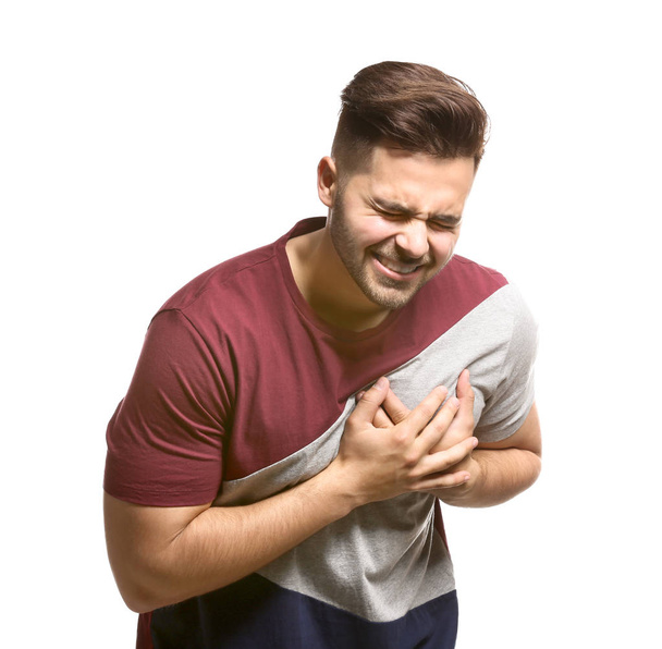Young man suffering from heart attack on white background - Photo, image