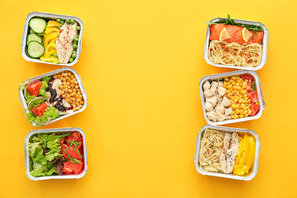 Many containers with delicious food on color background - Photo, Image