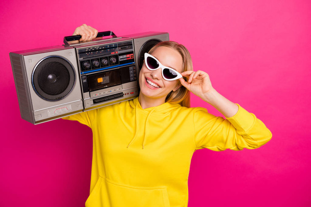 Photo of cool lady with vintage tape recorder on shoulder wear casual outfit isolated pink background - Foto, Imagen