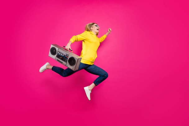 Full body photo of crazy lady jumping high rushing to student party wear casual outfit isolated pink background - Foto, immagini