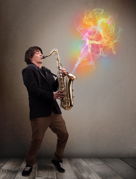 Attractive musician playing on saxophone with colorful abstract - Foto, Imagen