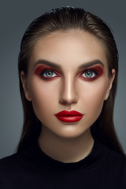 Close-up portrait of a beautiful fashion model with professional make-up. - Фото, изображение