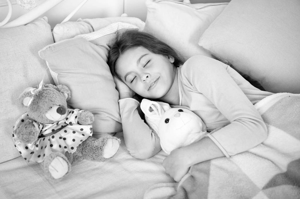 little child girl with xmas gift. happy new year. Christmas shopping. waiting for santa. Winter. small girl sleeping at home. christmas family holiday. The morning before Xmas. Sleep. Great present - 写真・画像