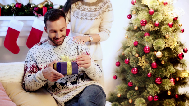 wife covering eyes of husband and giving present  - Footage, Video