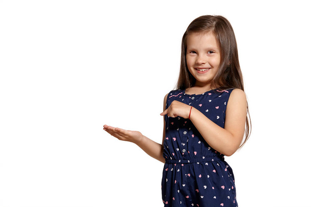 Close-up studio shot of beautiful brunette little girl posing isolated on white studio background. - Zdjęcie, obraz