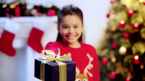 rack focus of happy kid holding present  - Πλάνα, βίντεο