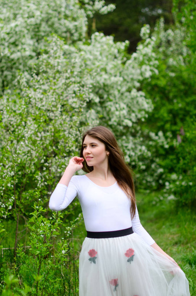 beautiful girl in a blooming Park - Photo, Image