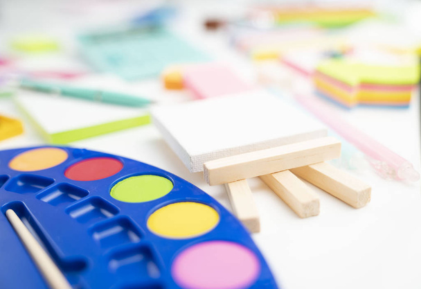 School supplies. Set of colorful school accessories isolated on the white table. - Foto, afbeelding