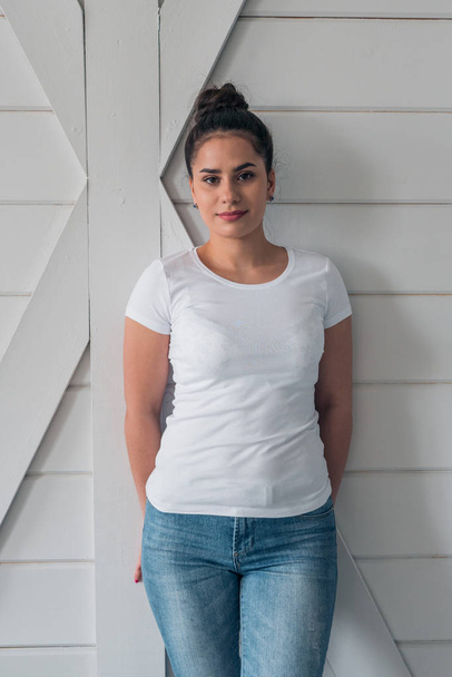 A beautiful girl in a white t-shirt. Layout for the design of everyday youth clothing - Фото, зображення