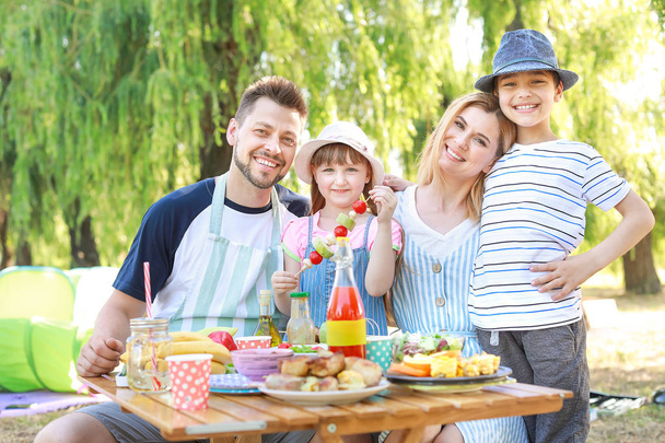 Happy family having picnic on summer day - Photo, Image