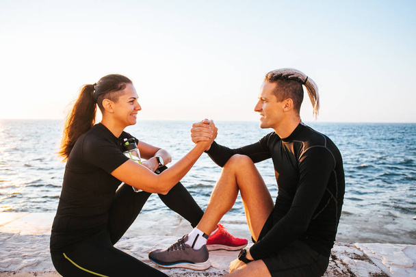 Young couple enjoying together after working out outdoors - Фото, зображення