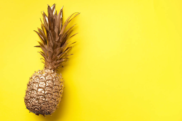 Creative layout. Gold pineapple on yellow background with copy space. Top view. Tropical flat lay. Exotic food concept, crazy trend. Banner - Fotoğraf, Görsel