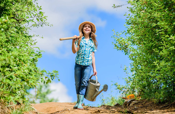 garden tools, shovel and watering can. kid worker sunny outdoor. family bonding. spring country side village. future success. little girl on rancho. summer farming. farmer little girl. I love my job - 写真・画像