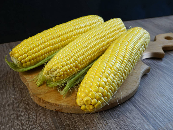       Close-up corn in front of the table.   - Photo, Image