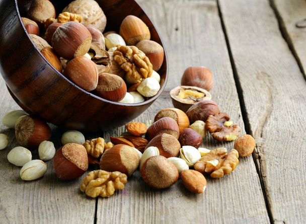 Mix nuts (almonds, hazelnuts, walnuts) on a wooden table - Photo, Image