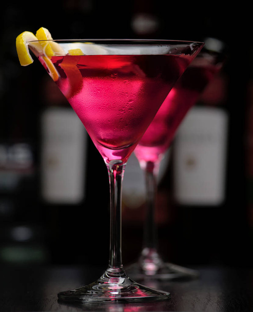 Two cosmopolitan drink in bar on black - Fotó, kép