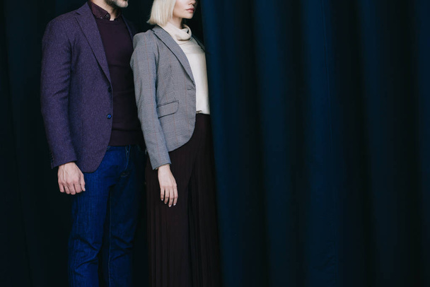 cropped view of elegant young woman and man near curtain - Фото, изображение