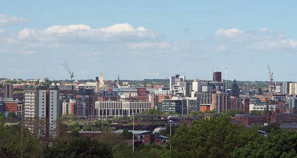 a wide cityscape view of leeds city centre taken from above showing office and apartment buildings the city hall and university area - Фото, зображення