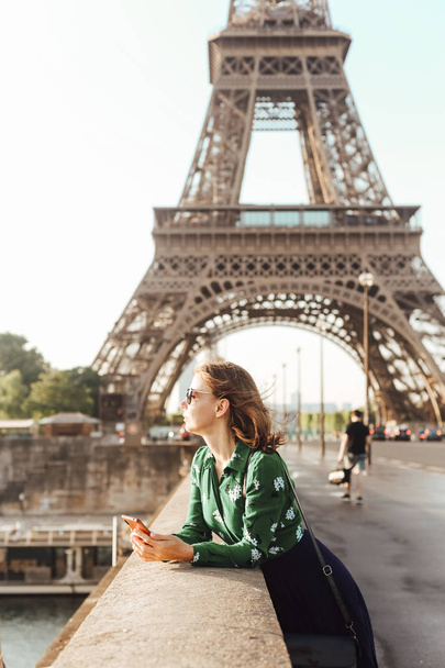 french manicure woman smartphone eiffel tower reflection glasses - Photo, Image
