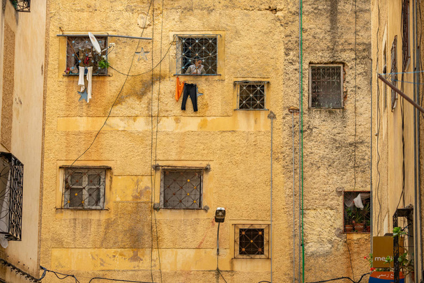 old house wall with windows in ancient street at sunny day, Fez, Morocco - 写真・画像