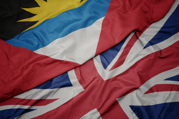 waving colorful flag of great britain and national flag of antigua and barbuda. - Photo, Image