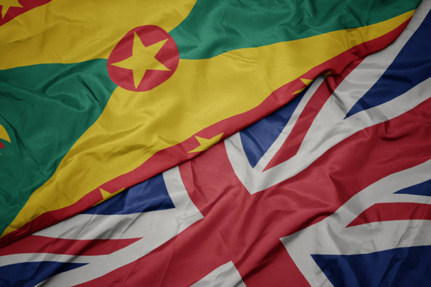 waving colorful flag of great britain and national flag of grenada. - Photo, Image