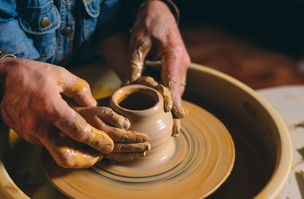 Pottery workshop. Grandpa teaches granddaughter pottery. Clay modeling - 写真・画像