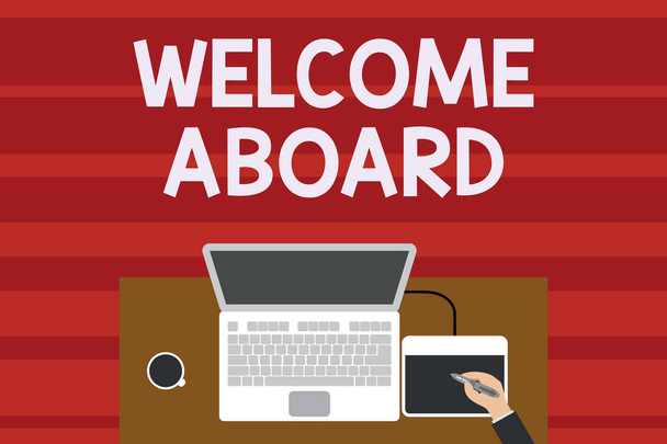 Text sign showing Welcome Aboard. Conceptual photo Expression of greetings to a demonstrating whose arrived is desired Upper view laptop wooden desk worker drawing tablet coffee cup office. - Photo, Image