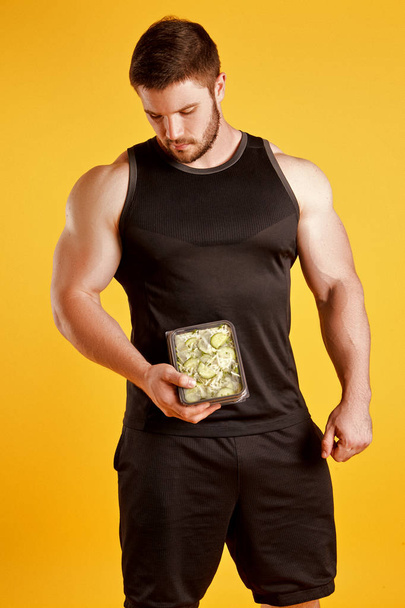 Handsome muscular man with food boxes - Zdjęcie, obraz