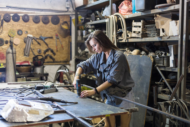 young woman working in a workshop - Photo, image