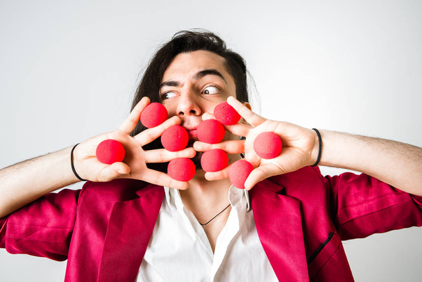 Magician with red balls in his outstretched hands. - Photo, Image