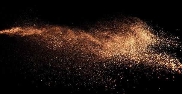 a shot from a firearm, an explosion of gunpowder on a black background, a bright flash with flying particles, abstract shape - 写真・画像