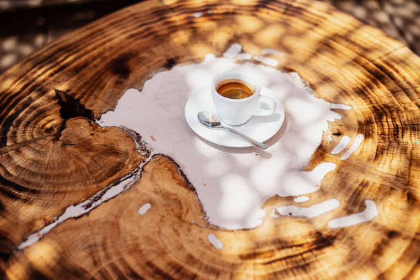 top view a cup of espresso coffee on wooden table background - Фото, зображення