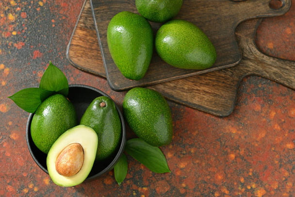 Fresh ripe avocados with boards on color background - Photo, Image