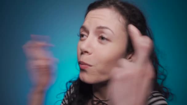 studio shot of curly brunette female praying with hope - Filmati, video