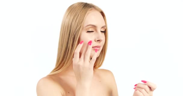 Woman Applying Cream on Face - Záběry, video