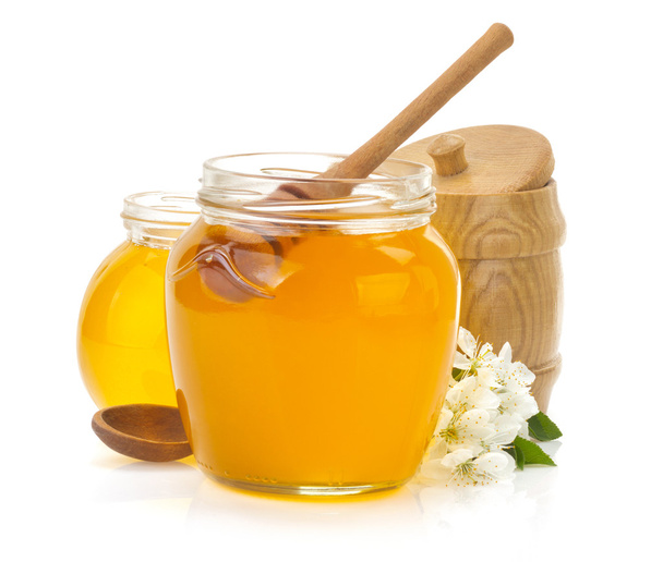 glass jar full of honey and stick - Foto, immagini