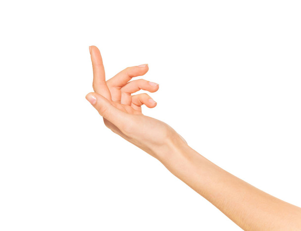 Close up picture of empty female hand holding something isolated on white - Foto, Imagem