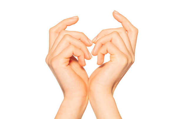 Pair of female hands touching with wrists and fingertips making heart sign, isolated on white background - Fotó, kép