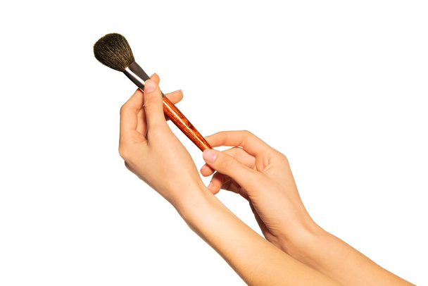 Close up picture of female hands holding makeup powder brush isolated on white background - Fotografie, Obrázek