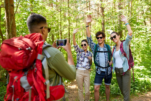 friends with backpacks being photographed on hike - Foto, afbeelding